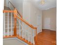 Bright entryway featuring hardwood floors, a staircase with wood railing, and neutral wall colors at 6948 Church Wood Ln, Huntersville, NC 28078