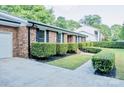 Classic brick home featuring manicured landscaping and a side-entry garage at 7416 Quail Ridge Dr, Charlotte, NC 28226