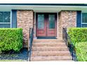 Inviting front entrance featuring a brick staircase and ornate glass double doors at 7416 Quail Ridge Dr, Charlotte, NC 28226