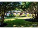 Well-maintained front lawn showcasing a brick home with lush, trimmed hedges at 7416 Quail Ridge Dr, Charlotte, NC 28226