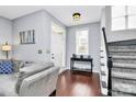 Welcoming entryway featuring hardwood floors, a staircase, and a view of the bright living area at 7544 Rolling Meadows Ln, Huntersville, NC 28078