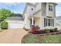 Charming two-story home with a detached garage and manicured landscaping at 7544 Rolling Meadows Ln, Huntersville, NC 28078