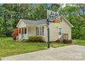 Single-Gathering home featuring a basketball hoop and landscaped yard at 772 Austin Rd, New London, NC 28127
