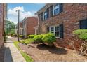 A row of brick townhomes showcases manicured landscaping and inviting curb appeal at 862 Mcalway Rd, Charlotte, NC 28211
