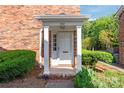 A covered entrance with white columns highlights the doorway of this brick home at 862 Mcalway Rd, Charlotte, NC 28211