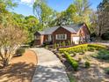 Attractive brick home with well-maintained landscaping, a winding driveway, and an attached garage at 961 Confederate Ave, Salisbury, NC 28144