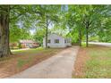 Well-maintained home with inviting curb appeal and mature trees and an extra long driveway at 104 Willetta Dr, Charlotte, NC 28217