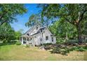 Expansive backyard with mature trees, a pergola, and a firepit, perfect for outdoor entertaining at 108 Stockton St, Shelby, NC 28150