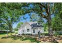 Lush backyard featuring mature trees, a well-maintained lawn, and an inviting garden area at 108 Stockton St, Shelby, NC 28150