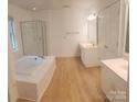 Elegant bathroom featuring a soaking tub and a glass shower at 12314 Chickasaw Dr, Huntersville, NC 28078