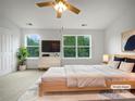 Serene main bedroom with large windows, a cozy bed, and modern furnishings, ideal for relaxation at 14056 Lyon Hill Ln, Huntersville, NC 28078