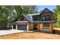 Charming two-story home with a 3 car garage, stone accents, and inviting covered front porch at 1408 Bloomsberry Ln, Waxhaw, NC 28173