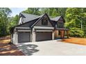 Beautiful two-story home featuring a 3-car garage, modern design, and well-manicured lawn at 1408 Bloomsberry Ln, Waxhaw, NC 28173