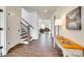 Bright foyer with hardwood floors, stairway, and a view into the living room at 18011 Wilbanks Dr, Charlotte, NC 28278
