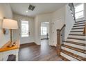 Inviting foyer with hardwood floors, a staircase with iron railings, and ample natural light at 18011 Wilbanks Dr, Charlotte, NC 28278