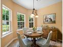 Cozy dining area bathed in natural light, featuring a quaint round table and a charming buffet at 2020 White Cedar Ln, Waxhaw, NC 28173