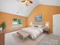 Serene primary bedroom featuring a vaulted ceiling, plush carpet, and a comfortable king bed at 2020 White Cedar Ln, Waxhaw, NC 28173