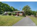 Lovely home with a well-kept lawn, featuring a brick facade and an inviting entrance at 3400 Barfield Dr, Charlotte, NC 28217