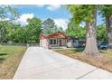 Charming single story home with a long driveway leading up to the entrance, and mature landscaping at 3932 Slagle Dr, Charlotte, NC 28215