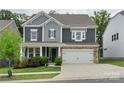 Beautiful two-story home with a stone-accented garage and well-maintained front yard at 4174 Charlton Rd, Fort Mill, SC 29715