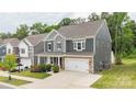 Two-story home with a stone-accented garage, well-kept lawn, and convenient driveway at 4174 Charlton Rd, Fort Mill, SC 29715