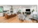 Bright open-concept living space with a kitchen island, dining area, and living room with stylish furnishings at 437 Chadmore South Dr, Charlotte, NC 28270