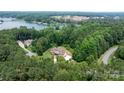 Breathtaking aerial view of a house nestled in lush greenery, near the tranquil waterfront and lake at 4616 Gold Finch Dr, Denver, NC 28037