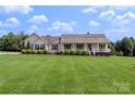 Beautiful ranch-style home featuring a large front yard, covered porch, and well-maintained landscaping at 4916 Ritchie Rd, Lincolnton, NC 28092