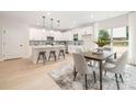 Bright kitchen featuring an island with bar seating, stainless appliances and adjacent dining area with backyard views at 515 Dixie Dr, Mooresville, NC 28115