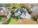 An aerial view of a two-story house with a dark roof, surrounding trees and shrubbery, plus a private driveway at 520 Beacon Knoll Ln, Fort Mill, SC 29708
