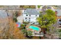 This overhead shot shows a beautiful backyard pool, patio with pergola, and a view of the home's rear exterior at 520 Beacon Knoll Ln, Fort Mill, SC 29708