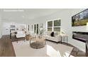 Bright open-concept living room showcasing seamless flow to the modern kitchen at 5540 Pamplona Way, Charlotte, NC 28214