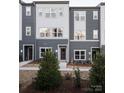 Exterior view of modern townhomes featuring coordinated color schemes and minimalist landscaping at 6013 Pivot Ct, Charlotte, NC 28205