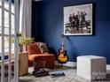 Stylish office with blue walls, decorated with musical themes, and bathed in natural light at 6013 Pivot Ct, Charlotte, NC 28205