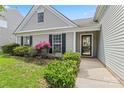 Inviting entrance to a well-maintained home with a beautifully landscaped front yard at 8309 Shinkansen Dr, Charlotte, NC 28213