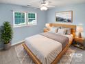 Calm bedroom featuring light blue walls, ceiling fan and natural wood furniture and neutral accents at 903 Furman Ct, Fort Mill, SC 29708