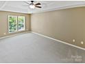 Spacious bedroom with plush gray carpeting, a trey ceiling and large windows offering ample light at 903 Furman Ct, Fort Mill, SC 29708