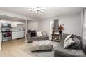 Inviting living room features modern gray sofas, a patterned ottoman, and a decorative ceiling light at 92 Saint Charles Ne Ave, Concord, NC 28025