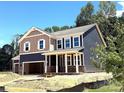 Beautiful two-story home with a two-car garage and welcoming covered porch at 9945 Cask Way, Huntersville, NC 28078