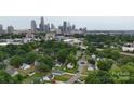 Panoramic aerial view of the city skyline with mature trees and residential neighborhood below at 1004 Johnson St, Charlotte, NC 28206