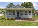 Charming single-story home with a welcoming front porch, well-maintained lawn, and inviting curb appeal at 1004 Johnson St, Charlotte, NC 28206