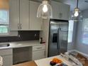 Bright kitchen featuring modern white cabinets, stainless steel appliances, and stylish pendant lighting at 1004 Johnson St, Charlotte, NC 28206
