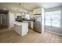 Bright, modern kitchen with stainless steel appliances, white cabinetry, and a spacious center island at 1004 Johnson St, Charlotte, NC 28206