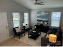 A cozy living room with neutral walls, ample seating, and bright natural light at 1004 Johnson St, Charlotte, NC 28206