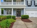 Inviting front entrance showcases a charming walkway, well-maintained landscaping, and black double doors with glass inserts at 1014 Harrogate Ln, Matthews, NC 28104