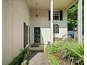 Inviting front porch with bench seating and charming details at 11121 Sevilla Ct, Charlotte, NC 28226