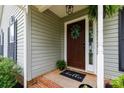 Inviting front porch with decorative wreath and a 'hello' door mat at 112 Brookshire Dr, Fort Mill, SC 29715