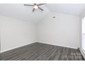 Bright living room featuring vaulted ceilings, modern flooring, and a ceiling fan at 112 Brookshire Dr, Fort Mill, SC 29715