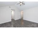 Spacious living room with vaulted ceiling, ceiling fan, and modern vinyl flooring at 112 Brookshire Dr, Fort Mill, SC 29715