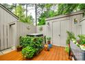Outdoor patio area features potted plants, charming decor, and a storage shed for a private, backyard space at 115 Pine Grove Cir, Clover, SC 29710